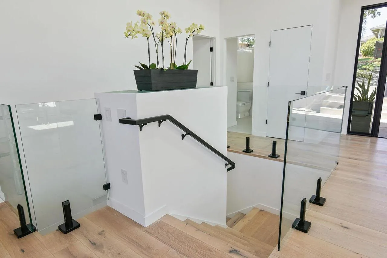 Modern stair landing with glass railing